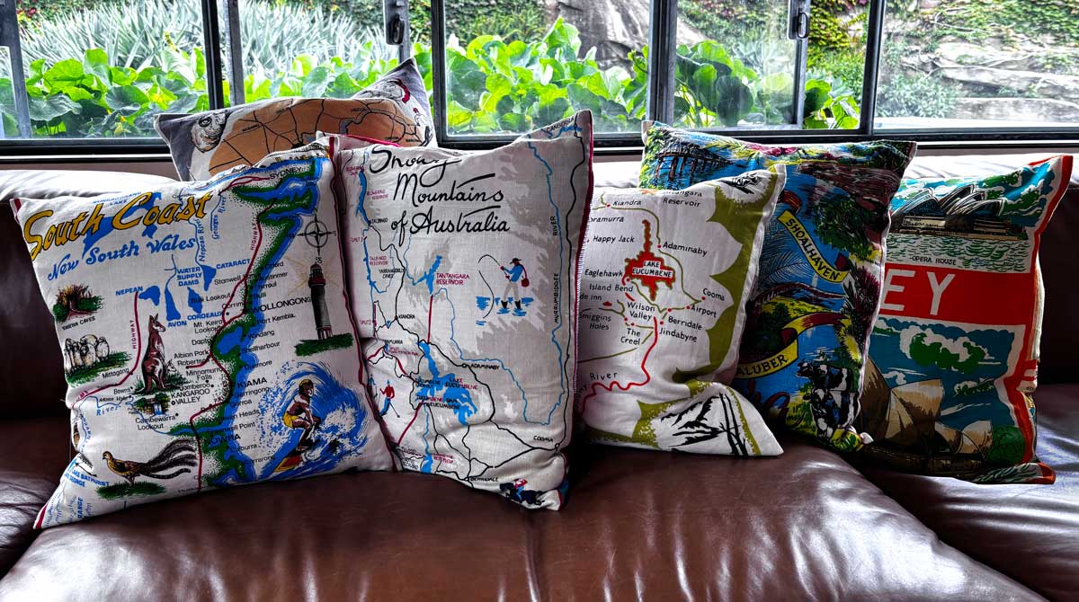 NSW souvenir teatowel cushion covers for sale on tan leather couch