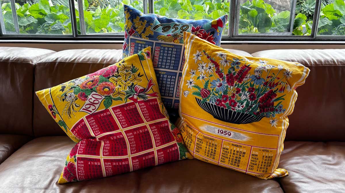 Calendar cushion covers on tan leather sofa