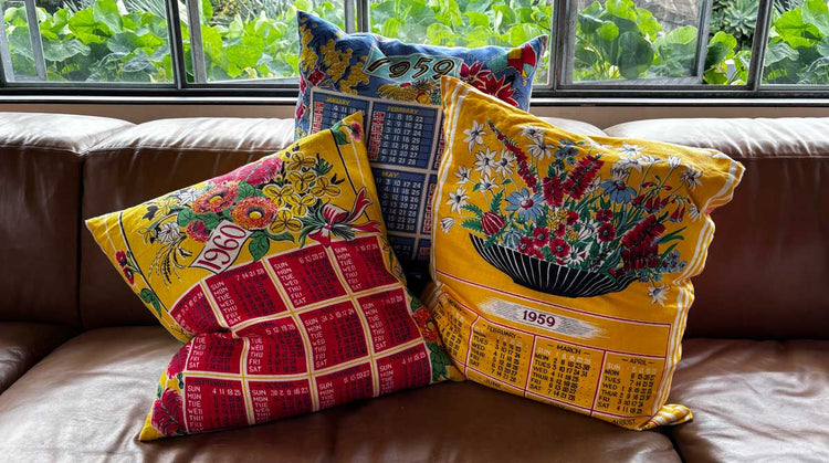 Calendar cushion covers on tan leather sofa