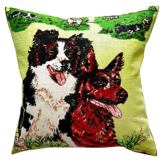 Decorative pillow with two dogs on a green linen teatowel, on a white background