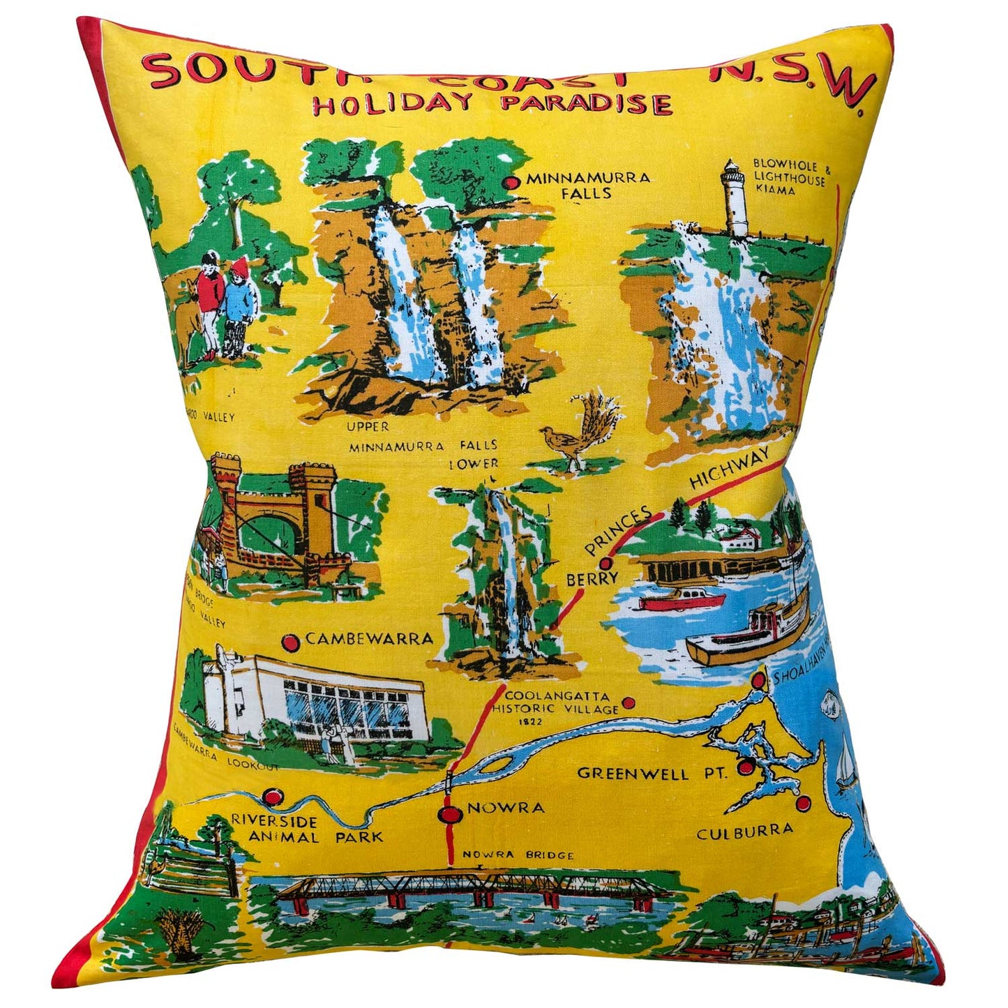 Decorative pillow repurposed from a colourful South Coast teatowel, featuring scenes, landmark and map, on white background