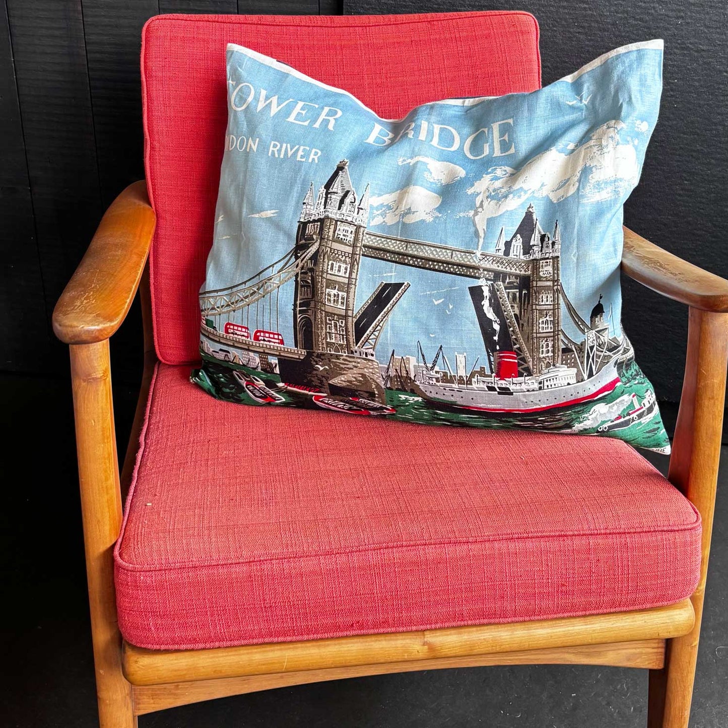 Decorative vintage linen teatowel pillow with Tower Bridge and Thames River design on mcm chair