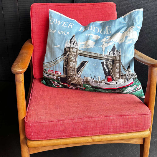 Decorative vintage linen teatowel pillow with Tower Bridge and Thames River design on mcm chair