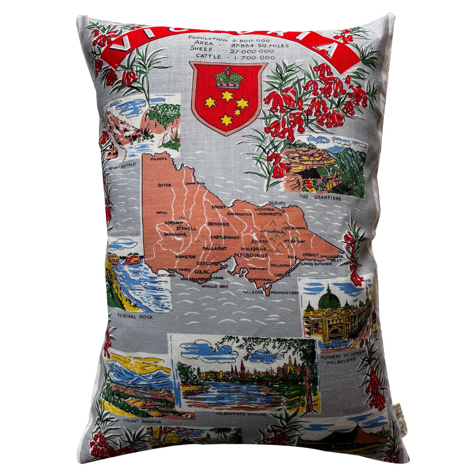 Decorative pillow with a map of Victoria, state flowers, scenic images and emblem design on a white background