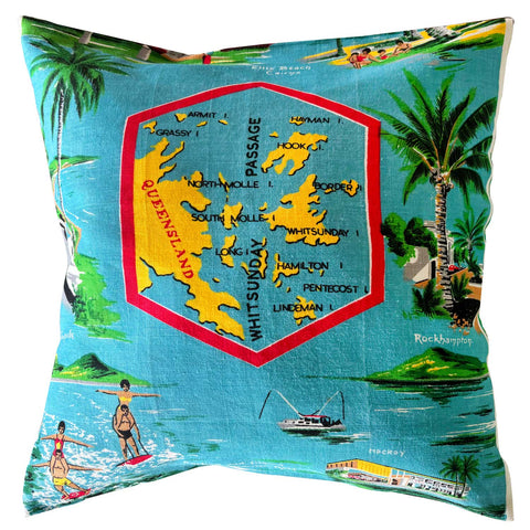 Decorative pillow with a map design of Whitsunday Islands and beach scenes on a white background
