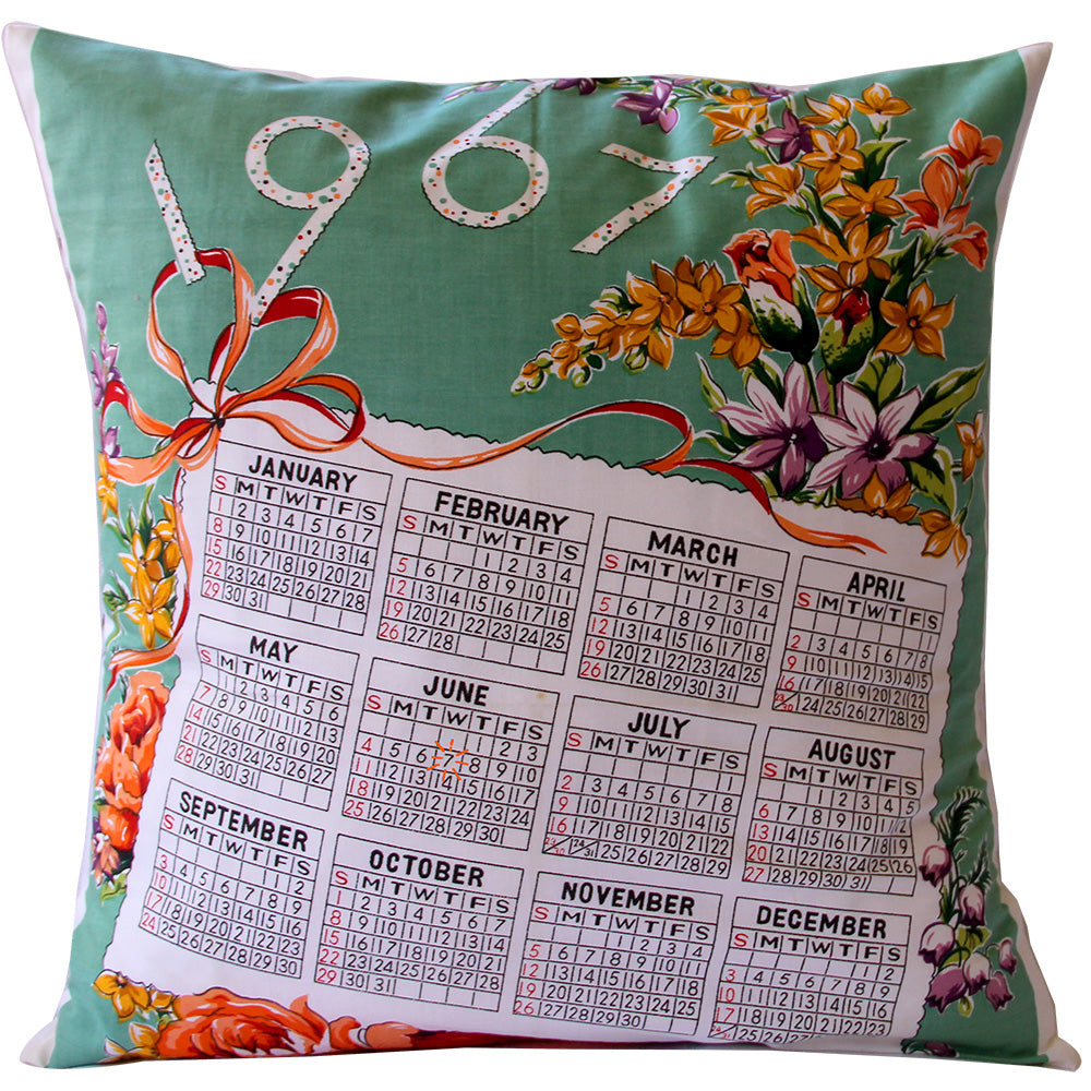 A floral cushion cover featuring a printed 1967 calendar design with each month's flowers and an invisible zip closure.