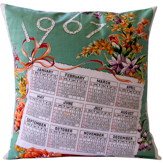 A floral cushion cover featuring a printed 1967 calendar design with each month's flowers and an invisible zip closure.